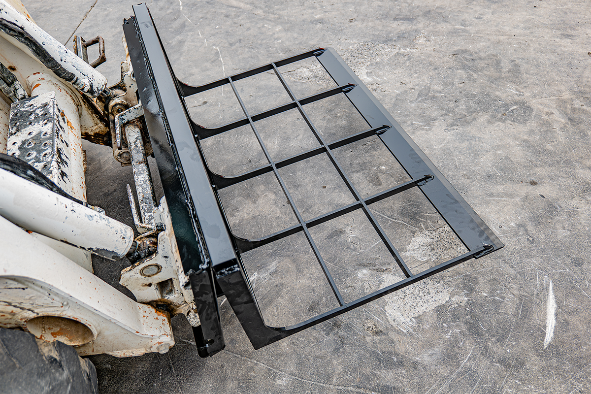 Black skid steer loader land leveler attachment with steel grate frame