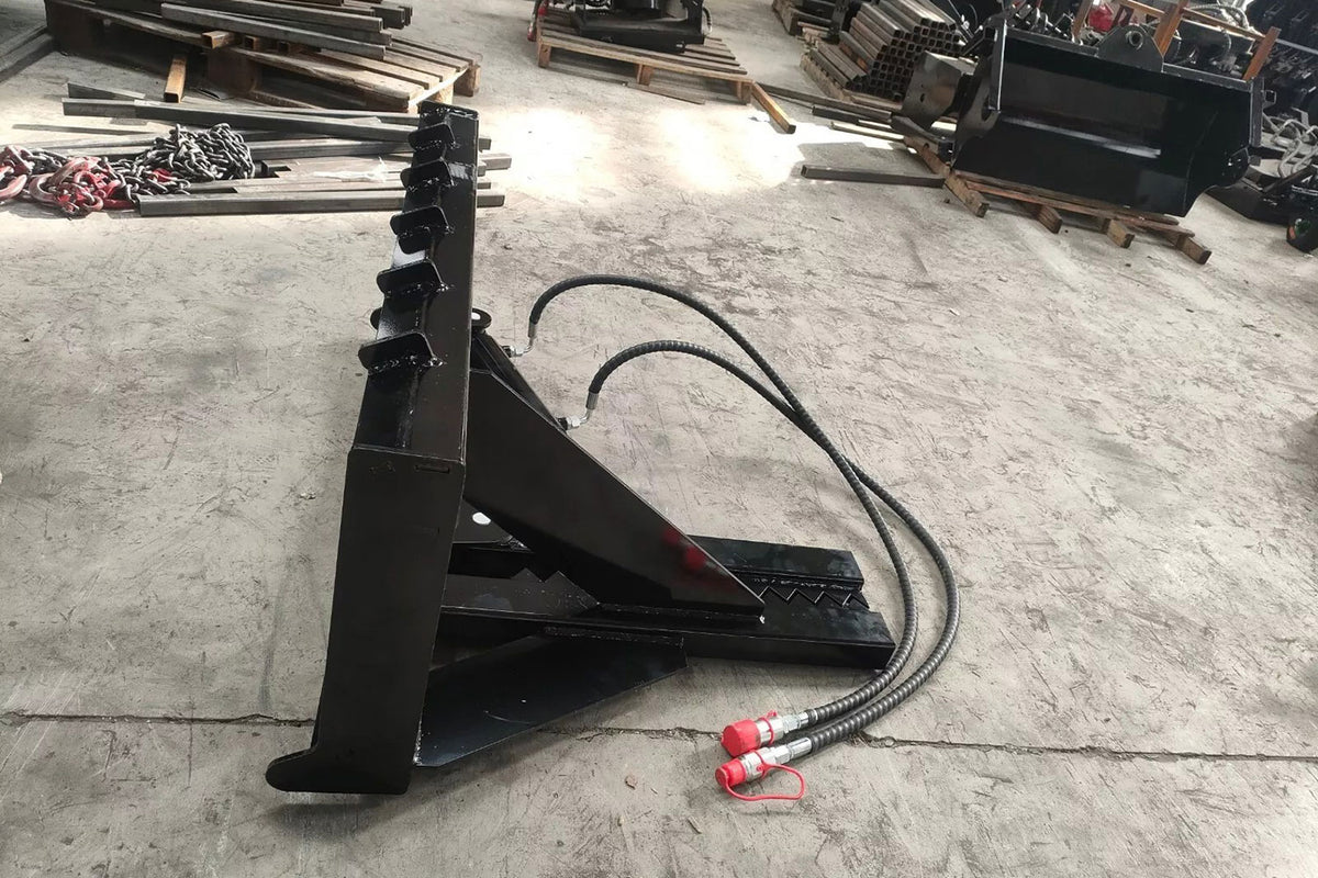 Black skid steer tree puller attachment with hydraulic hoses and toothed clamp