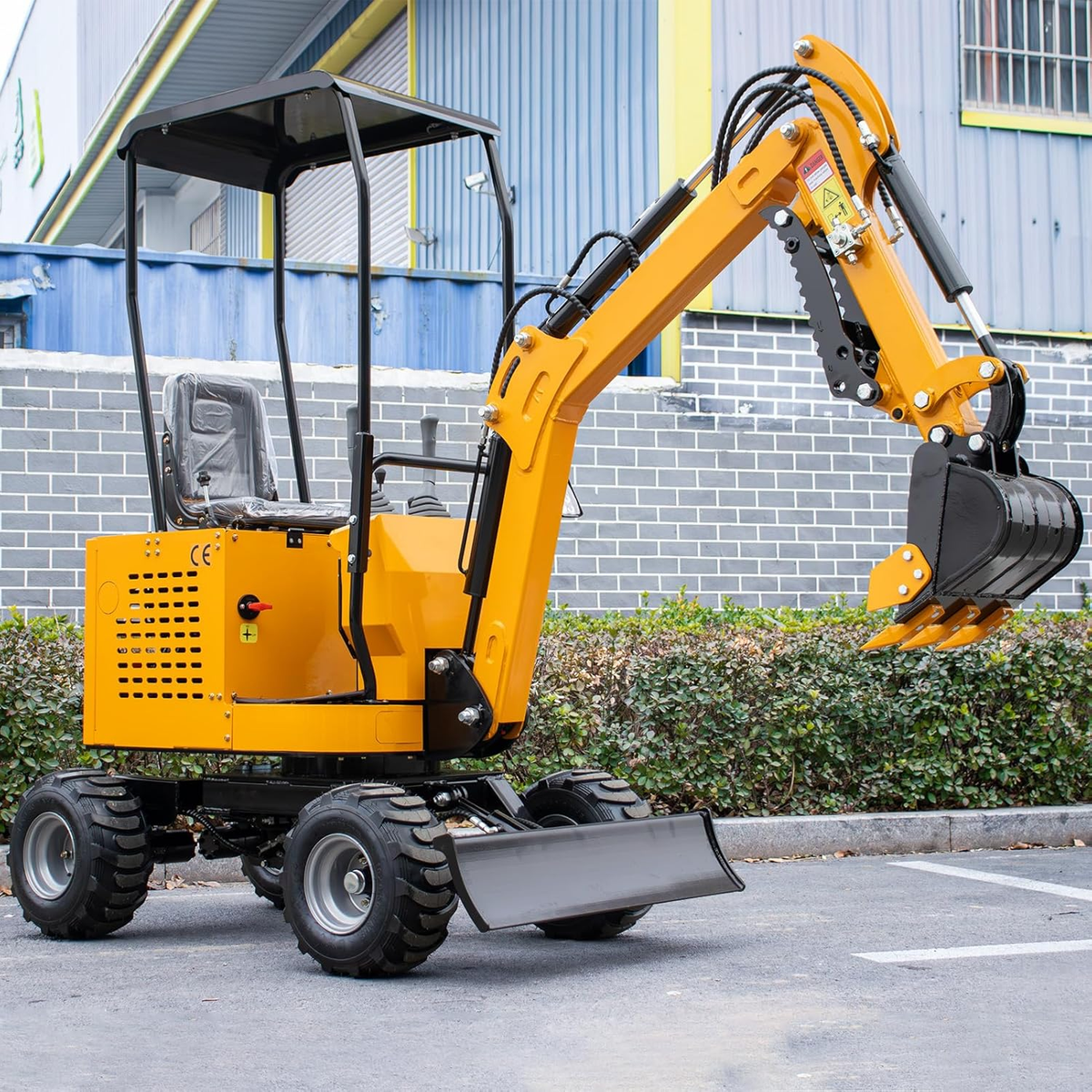 Yellow 1 ton mini excavator with wheels, cab, bucket and mechanical thumb clamp
