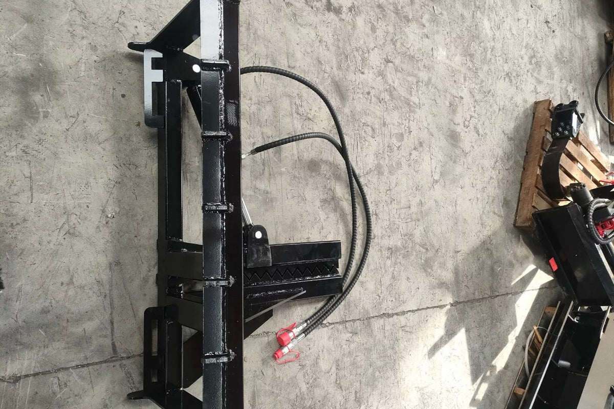 Black skid steer tree puller attachment with hydraulic hoses and universal mount