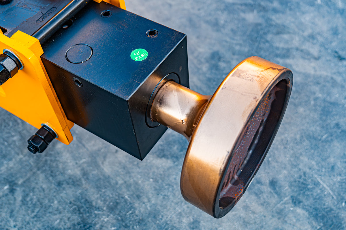 Hydraulic breaker and pile driver attachment for skid steer loader, black and yellow steel housing